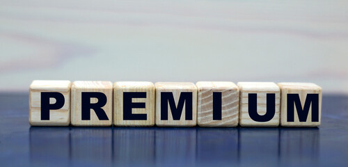 concept word PREMIUM on wooden cubes on a beautiful background