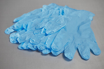 Blue medical gloves on a gray background
