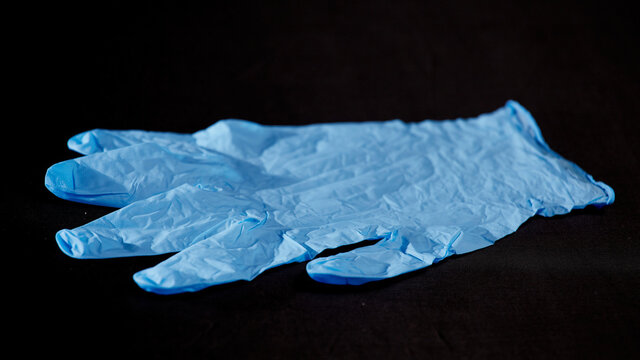 Blue medical gloves on a black background