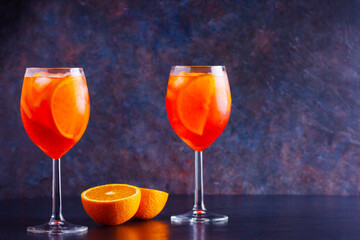 Aperol spritz cocktail on dark background. Two glasses of aperol spritz. Summer cocktail in glass