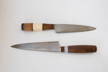 Two Old vintage homemade kitchen or household knife with a wooden handle and a blade from a saw blade isolated on a white background