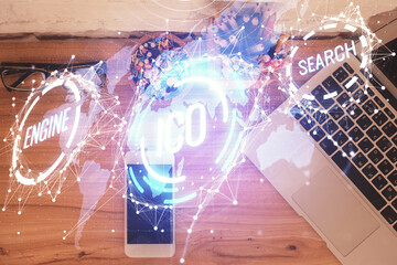 Double exposure of blockchain theme hologram over table with phone. Top view. Crypto technology...