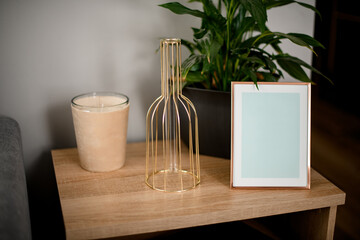 view on wooden surface on which stands different accessories and green plant