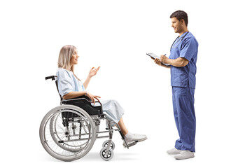 Young female patient in a wheelchair talking to a doctor