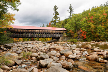 Albany Covered Bridge over Swift River in New Hampshire in autumn. The Albany Covered Bridge was...