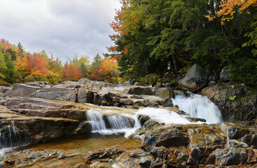 Beautiful fall foliage along the Swift River at White Mountain, New Hampshire. Swift River is located along the famous Kancamagus Highway in NH, USA