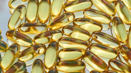 Fish oil, omega 3 gel capsules scattered, lying randomly. Health care, vitamins and treatment...