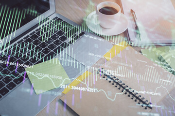 Multi exposure of forex graph drawing and desktop with coffee and items on table background. Concept of financial market trading