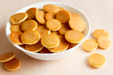 Mini pancake cereal for breakfast. Mini pancake cereal is new trend. Mini pancakes cereal served for breakfast or snack.