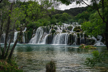 Fototapeta na wymiar Beautiful Krka waterfalls with a lush green trees and turquoise water. Croatia, 28th April 2015. 