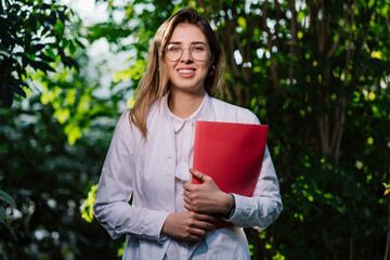 Fototapeta premium Young female scientist looking at the camera