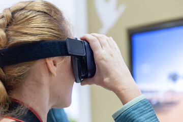 Young Cocausian Woman using Virtual Reality headset 