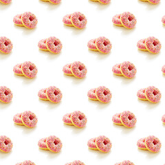 Obraz na płótnie Canvas Pattern of two donuts with pink icing and colored sprinkles on a white background.