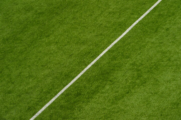 Obraz premium Green Synthetic Grass Sports Field With White Line Shot From Above. Sports Or Leisure Concept