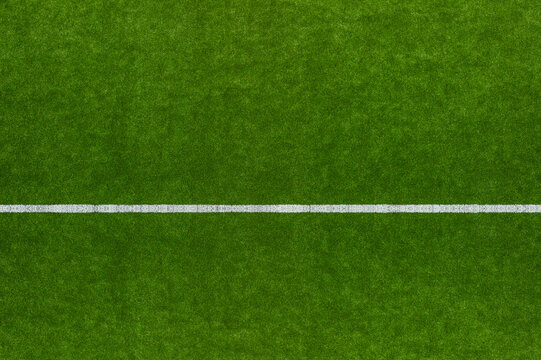Green Synthetic Grass Sports Field With White Line Shot From Above. Sports Or Leisure Concept