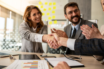 Businesswoman giving a handshake to her colleague