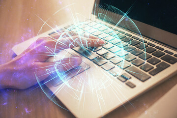 Double exposure of woman hands typing on computer and business theme hologram drawing. Success...