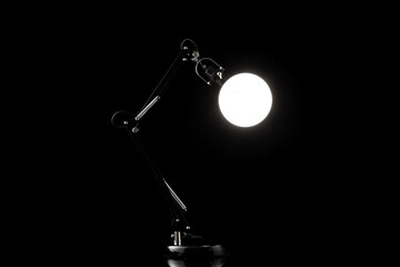 Office modern table lamp isolated on black. Light furniture for night room design or business decor.