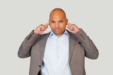 african american young man guy with angry expression covering his ears with his fingers for loud music noise