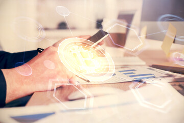 Double exposure of man's hands holding and using a phone and crypto currency blockchain theme drawing.