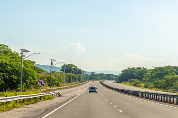 Merge/ Merging traffic lanes on the P.J. Patterson (East West) Highway through May Pen in Clarendon parish, Jamaica.