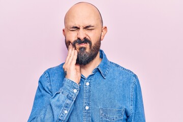 Young handsome man wearing casual clothes touching mouth with hand with painful expression because of toothache or dental illness on teeth. dentist
