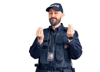 Young handsome man wearing police uniform doing money gesture with hands, asking for salary...