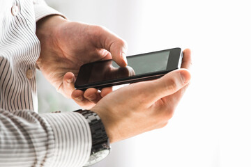 Close up of a man using mobile smart phone