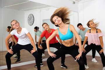 Teens practicing dance with female trainer