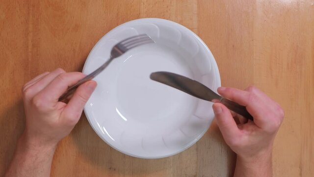 Sitting with an empty plate at the table, waiting for food