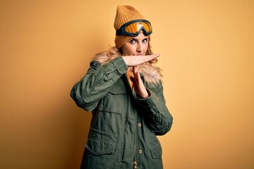 Middle age beautiful blonde skier woman wearing snow sportwear and ski goggles Doing time out...