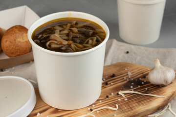 Eco packaging - soup in a craft glass for soup for a delivery service. Vegan food.