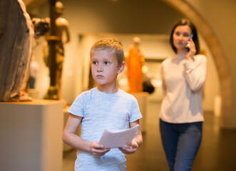 Boy with mother visiting museum