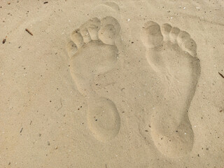 Two well-shaped human footprints in the sand