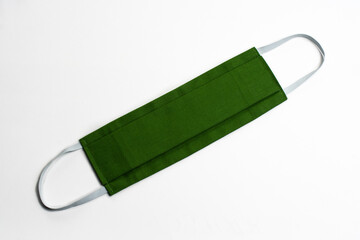 Beautiful green medical, fabric mask frontal from coronavirus, covid-19 and polluted air on white...