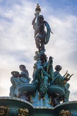 Fototapeta na wymiar Statue on the top of Ross Fountain in Princes Street Gardens in Edinburgh city, UK