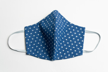 Beautiful blue medical, fabric mask frontal in an asterisk from coronavirus, covid-19 and polluted...