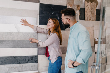 Middle age couple choosing accessories and utensils for their new bathroom