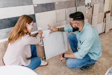 Middle age couple choosing accessories and utensils for their new bathroom