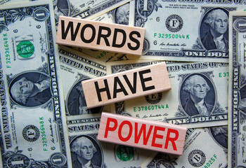 Concept text 'words have power' on wooden blocks on a beautiful background from dollar bills....