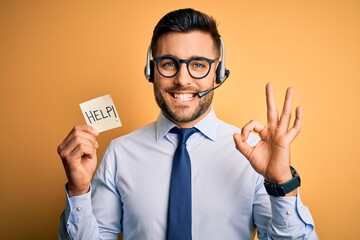 Business operator man with customer service headset from call center offering help and support doing ok sign with fingers, excellent symbol