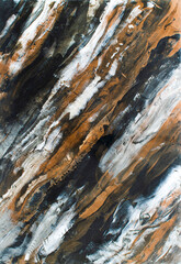 Textured paint floor with transitions of white, black and brown color. Abstract intertwined camouflage background of brushed black white and brown colors.