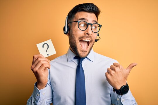 Business operator man with customer service headset from call center showing question mark pointing and showing with thumb up to the side with happy face smiling