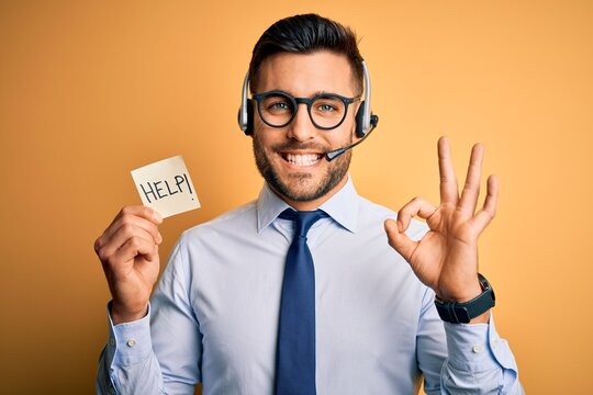 Business operator man with customer service headset from call center offering help and support doing ok sign with fingers, excellent symbol