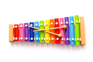 Rainbow colored wooden toy xylophone with two sticks on white background.