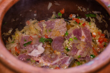 Cooking vegetables and meat in clay pot