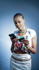 Portrait of pretty Fulani Nigerian woman making an online purchase with her mobile phone