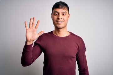 Young handsome hispanic man wearing casual shirt standing over white isolated background showing...