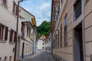 narrow street in the old town of Ljubljana against the backdrop of the fortress
