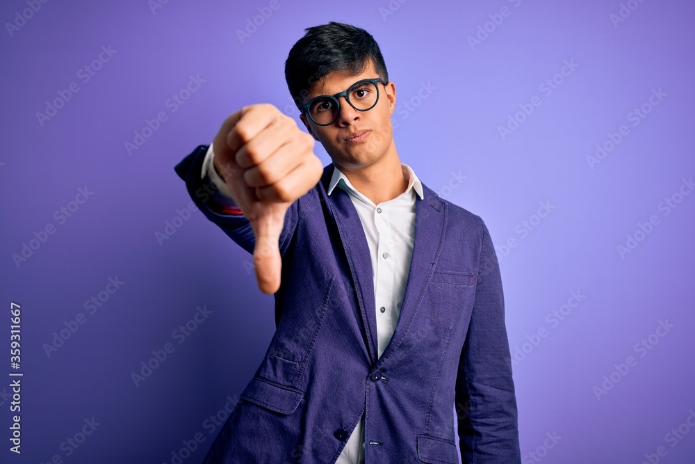 Poster Young handsome business man wearing jacket and glasses over isolated purple background looking unhappy and angry showing rejection and negative with thumbs down gesture. Bad expression.